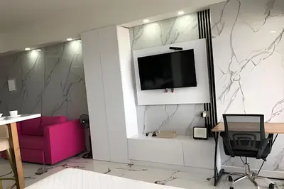 a living room with a tv on a wall at Escape to Paradise - Oceanfront in Cartagena in Cartagena de Indias