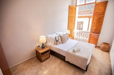 a small bedroom with a bed and a window at Historic Getaway with Breakfast in Cartagena de Indias