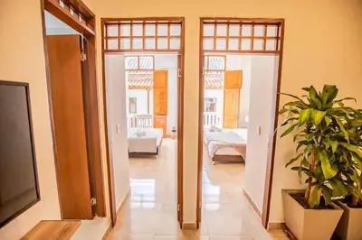 a room with two doors and a bedroom with a plant at Historic Getaway with Breakfast in Cartagena de Indias