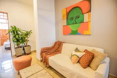 a living room with a couch and a painting on the wall at Historic Getaway with Breakfast in Cartagena de Indias