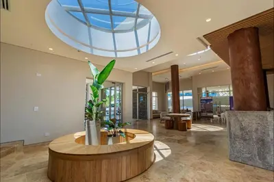 a lobby with a circular table and a glass ceiling at Aparta Suite en Santamarina - Escápate al Caribe in Santa Marta