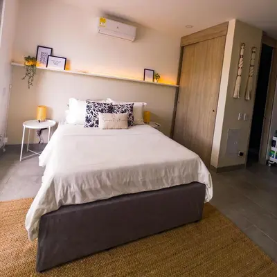 a bedroom with a large bed with white sheets and pillows at Aparta Suite en Santamarina - Escápate al Caribe in Santa Marta