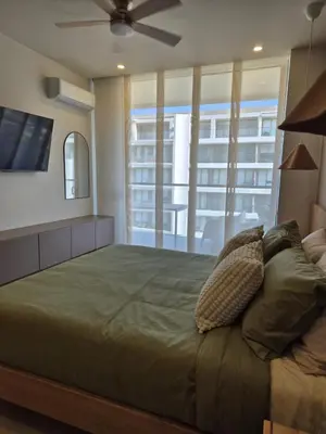 a bedroom with a large bed with a flat screen tv at Apartamento moderno con vista al mar y piscinas 1 habitación con balcón en Manzanillo,Cartagena in Cartagena de Indias