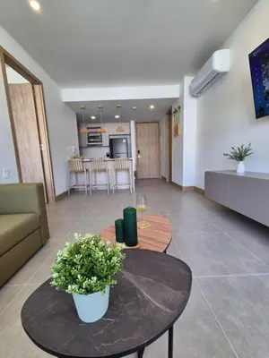 a living room with a table and a kitchen at Apartamento moderno con vista al mar y piscinas 1 habitación con balcón en Manzanillo,Cartagena in Cartagena de Indias