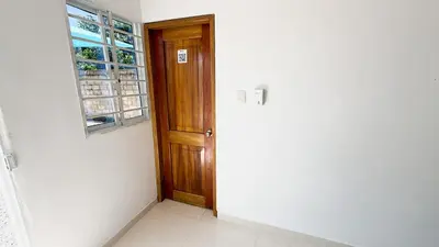 an empty room with a wooden door and a window at Cabaña Datalu 1 in Coveñas