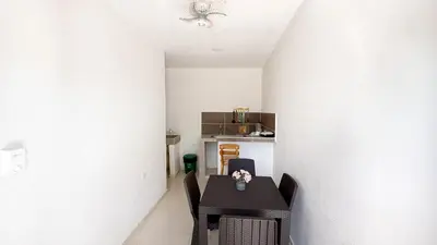 a dining room with a black table and chairs at Cabaña Datalu 1 in Coveñas