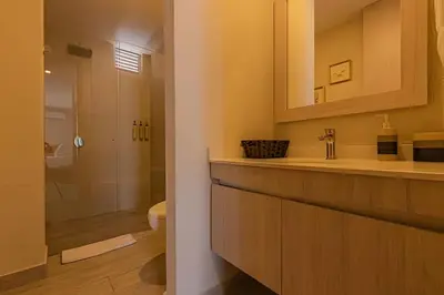 a bathroom with a sink and a toilet and a mirror at Lujoso apartamento con jacuzzi - Dominique in Cartagena de Indias