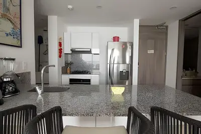 a kitchen with a granite counter top with a refrigerator at Lujoso Apto de 1 Habitación en Piso 14-Morros City in Cartagena de Indias