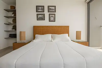 a large white bed in a bedroom with pictures on the wall at Lujoso Apto de 1 Habitación en Piso 14-Morros City in Cartagena de Indias