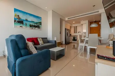 a living room with a blue couch and a table at Condominio H2-Luxurious 2 BR / 16th F - Bocagrande in Cartagena de Indias