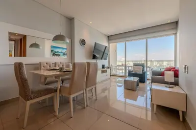 a dining room and living room with a table and chairs at Condominio H2-Luxurious 2 BR / 16th F - Bocagrande in Cartagena de Indias