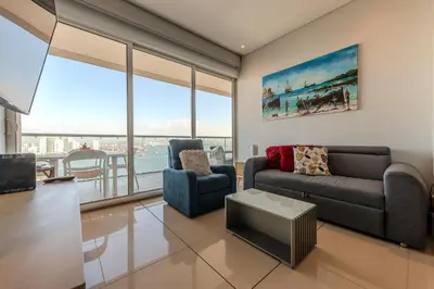 a living room with a couch and a table at Condominio H2-Luxurious 2 BR / 16th F - Bocagrande in Cartagena de Indias