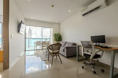 a living room with a couch and a table and chairs at 16th Floor Infinitum 1 Bedroom Apt in Cartagena de Indias