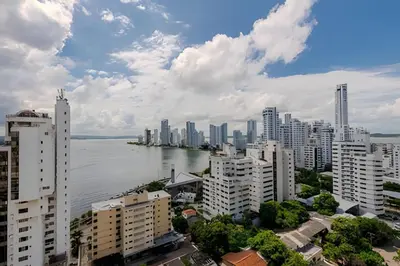 a city with a body of water and buildings at 16th Floor Infinitum 1 Bedroom Apt in Cartagena de Indias