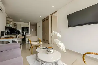 a living room with a couch and a table at 16th Floor Infinitum 1 Bedroom Apt in Cartagena de Indias