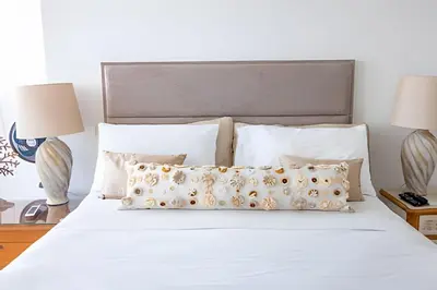 a bed with white sheets and pillows and two lamps at Espectacular Vista desde Piso 17 -Morros City 1701 in Cartagena de Indias
