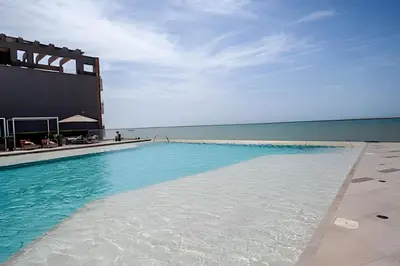 a swimming pool with the ocean in the background at Espectacular Vista desde Piso 17 -Morros City 1701 in Cartagena de Indias