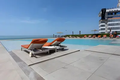 two lounge chairs sitting next to a swimming pool at Espectacular Vista desde Piso 17 -Morros City 1701 in Cartagena de Indias