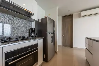 a kitchen with a stove and a refrigerator at 1702 Morros City - Espectacular Apto en Bocagrande in Cartagena de Indias