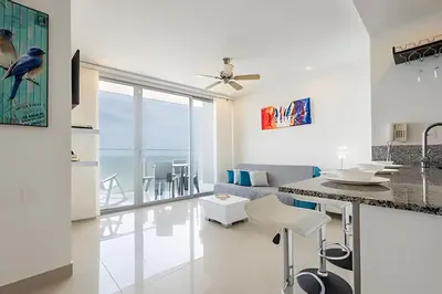 a kitchen and living room with a view of the ocean at 1702 Morros City - Espectacular Apto en Bocagrande in Cartagena de Indias