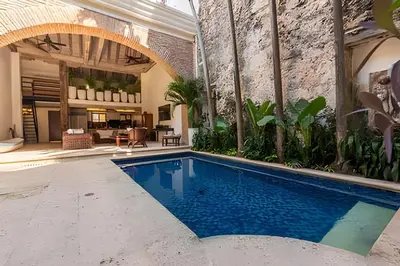 a swimming pool in a room with a brick wall at Casa de 3 Hab en la Ciudad Amurallada con Piscina in Cartagena de Indias