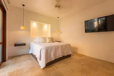 a bedroom with a bed and a flat screen tv at Casa de 3 Hab en la Ciudad Amurallada con Piscina in Cartagena de Indias