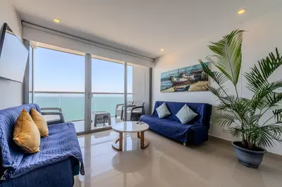 a living room with two blue couches and a table at 1704 Morros City - Espectacular Apto en Bocagrande in Cartagena de Indias