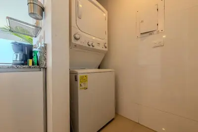 a small kitchen with a refrigerator and a microwave at 1704 Morros City - Espectacular Apto en Bocagrande in Cartagena de Indias