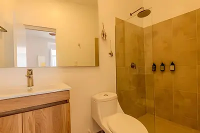 a bathroom with a toilet and a shower at Casa Encanto - Corazón de Getsemaní in Cartagena de Indias