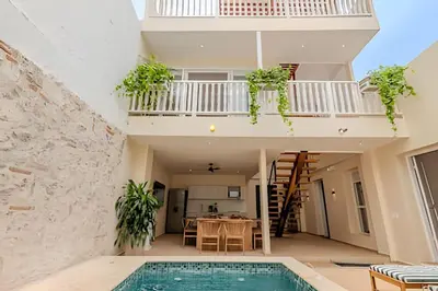 a villa with a swimming pool and a house at Casa Encanto - Corazón de Getsemaní in Cartagena de Indias
