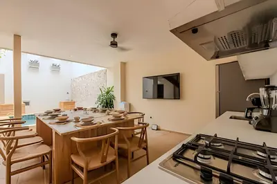a kitchen with a table and chairs and a stove at Casa Encanto - Corazón de Getsemaní in Cartagena de Indias