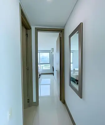 a hallway with a mirror on the wall at 1705 Palmetto Beach -17th Floor Palmetto Beach in Cartagena de Indias