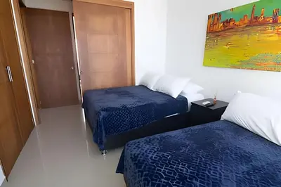 a hotel room with two beds and a painting on the wall at Espectacular Vista Al Mar - Edificio Infinito 1802 in Cartagena de Indias
