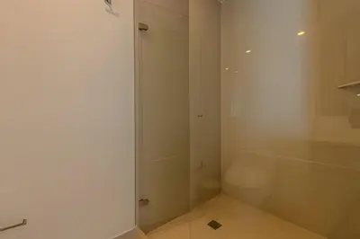 a white bathroom with a shower and a toilet at Espectacular Vista al Mar en Morros City piso 19 in Cartagena de Indias