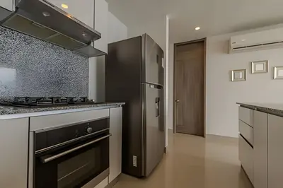 a kitchen with a stove and a refrigerator at Espectacular Vista al Mar en Morros City piso 19 in Cartagena de Indias