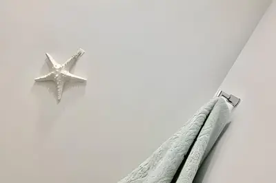 a starfish hanging from a rope next to two buildings at Lujoso Apto de 1 Hab en Piso 19- Infinitum in Cartagena de Indias