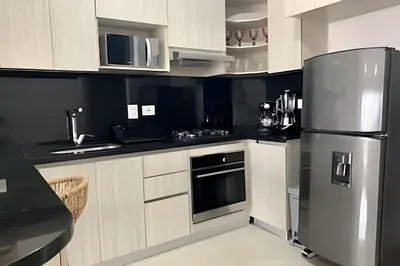 a kitchen with a stainless steel refrigerator at Lujoso Apto de 1 Hab en Piso 19- Infinitum in Cartagena de Indias