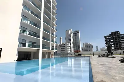 a swimming pool in front of a building at Lujoso Apto de 1 Hab en Piso 19- Infinitum in Cartagena de Indias