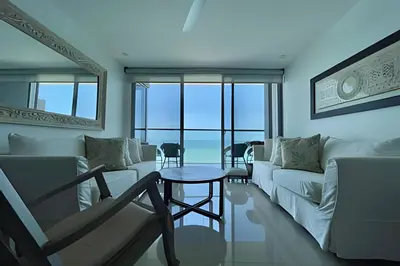 a living room with a white couch and a table at Lujoso Apto de 2 Hab en piso 20 - Morros City in Cartagena de Indias