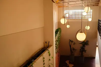 a hallway with a staircase with lights and plants at Espectacular Vista al Castillo de San Felipe! in Cartagena de Indias