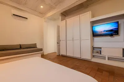a bedroom with a bed and a flat screen tv at Casa de 5 Hab en la Ciudad Amurallada con Piscina in Cartagena de Indias