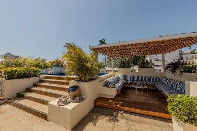 a rooftop deck with a bench and a pergola at Casa de 5 Hab en la Ciudad Amurallada con Piscina in Cartagena de Indias