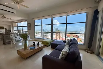 a living room with a couch and a large window at Espectacular apto de 2 hab en Centro Histórico in Cartagena de Indias