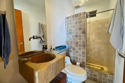 a bathroom with a wooden tub next to a toilet at Espectacular apto de 2 hab en Centro Histórico in Cartagena de Indias