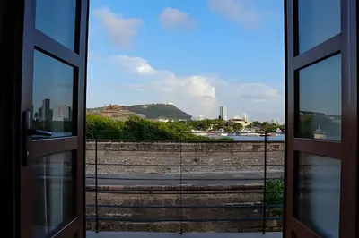 an open door with a view of a city at Relaxing New Apt w/ Balcony in Getsemani! in Cartagena de Indias