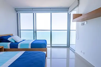 a room with two beds and a window at Hermoso Apto Frente al Mar - Morros City piso 9 in Cartagena de Indias