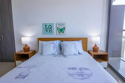 a bedroom with a bed with a face on it at Hermoso Apto Frente al Mar - Morros City piso 9 in Cartagena de Indias