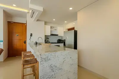 a kitchen with a marble counter top and a refrigerator at Espectacular Vista Al Mar - Edificio Infinito 702 in Cartagena de Indias