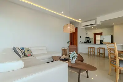 a living room with a white couch and a table at Espectacular Vista Al Mar - Edificio Infinito 702 in Cartagena de Indias