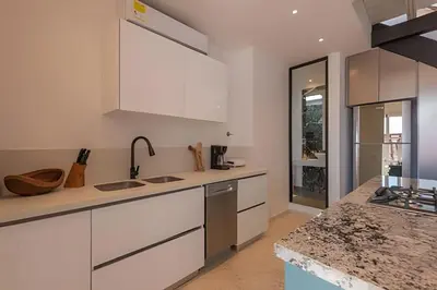 a kitchen with white cabinets and a counter top at El Mirador de la Catedral - Centro Histórico in Cartagena de Indias